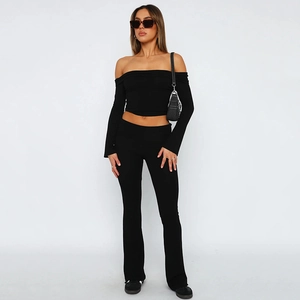 Detail of black two-piece set featuring off-shoulder crop top and high-waisted flared pants