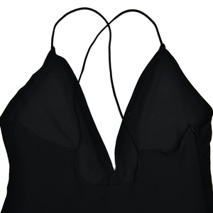 Detailed view of sexy deep V-neckline and ultra-thin spaghetti straps on black dress