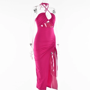 Detail of fuchsia halter dress featuring front cutout and elegant ruched side texture