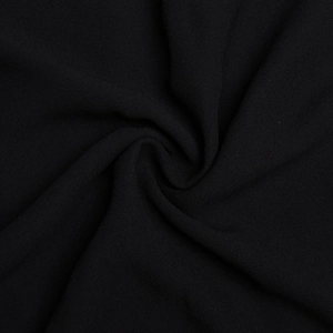 Detail shot of black chiffon fabric showing soft sand texture and elegant draped layers