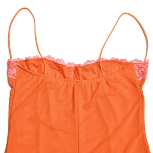 Détail du caraco en résille orange avec bordure en dentelle rose et fines bretelles
