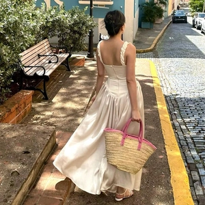Elegant backless maxi dress in beige with ruffled straps and a flowing skirt