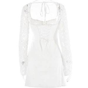 Detailed back view of a white lace mini dress with corset ties and halter neck