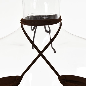 Detailed close-up of dark brown knit halter dress with adjustable cross-tie neck straps
