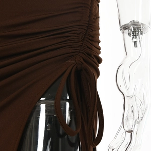 Detailed close-up of side ruched drawstring design on a deep brown knit dress