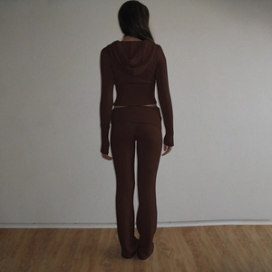 Detail view of dark brown knitted hoodie set showing the back silhouette and flared trousers