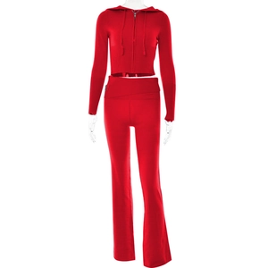 Detail of red knit hoodie set showing ribbed waist and flared trousers on a mannequin
