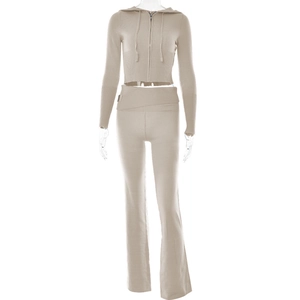 Detail of beige knit set featuring ribbed cuffs and high-waisted flared trousers