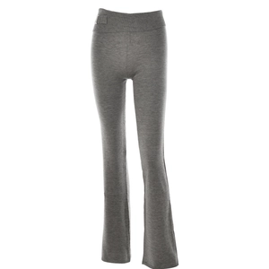 Detail of grey knitted flared pants showing the wide ribbed waistband and metal buckle