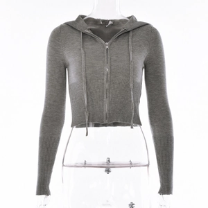 Detail of grey knitted crop hoodie showing ribbed cuffs and silver metal zipper closure
