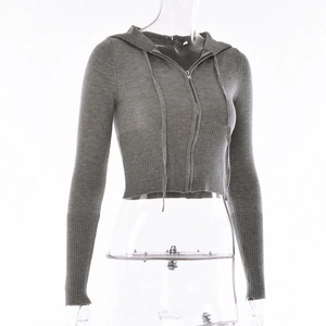 Detailed macro view of the grey knitted cropped hoodie with metal zipper and ribbed cuffs