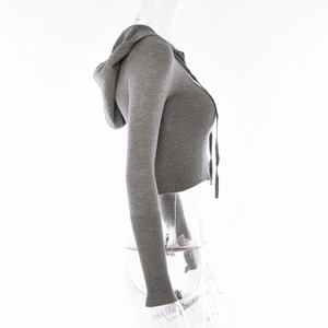 Detail view of grey knitted crop hoodie featuring ribbed cuffs and drawstring hood design