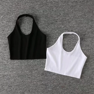 Flat lay detail of black and white halter neck crop tops in ribbed elastic fabric