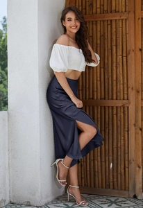 Detail view of navy blue satin midi skirt with elegant side slit and elastic waist design