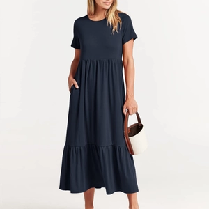 Detail view of navy blue tiered maxi dress featuring hidden side pockets and soft pleats