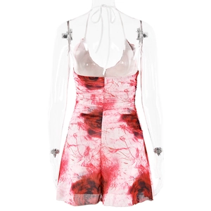 Back view of bodycon halter dress featuring red rose prints and tie-up strap details
