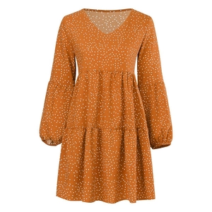 Detail of V-neck tiered polka dot dress with elastic cuffs and ruffled layers in orange-brown