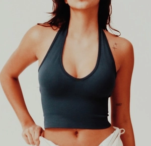 Detailed close-up of seamless dark blue halter neck crop top with soft cotton stretch fabric