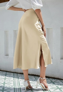 Detailed view of champagne satin midi skirt with side slit and elegant silk texture