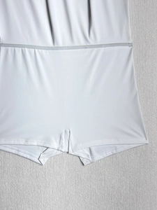 Detail of white stretch skort showing the built-in safety shorts and seamless waist stitching