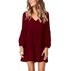 Detail view of burgundy V-neck tiered dress featuring lantern sleeves and ruffled hem