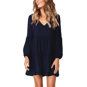 Detail of navy V-neck long sleeve dress with layered ruffle hem and chiffon texture