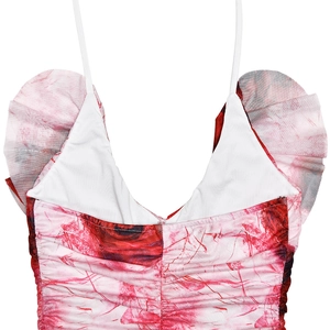 Detail of red floral print dress featuring deep V-neckline and ruffled ruched texture