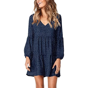 Detail view of V-neck long sleeve tiered dress with white polka dots on navy blue fabric