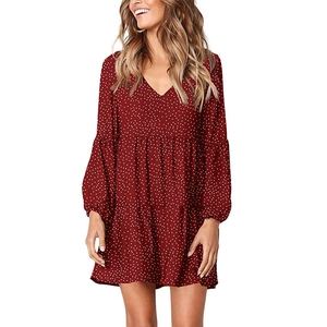 Detail of burgundy V-neck dress with white polka dots and layered ruffle hem design