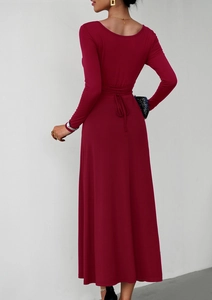 Detail view of the elegant deep red long-sleeved dress featuring waist tie and A-line hem