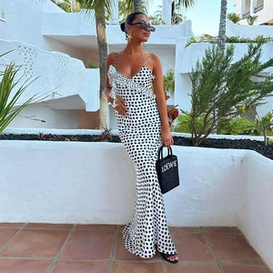 Detail of polka dot satin maxi dress featuring ruffle neckline and elegant open back design