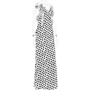 Detailed view of large black and white polka dot dress with floral shoulder accent