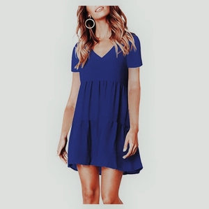 Detail view of royal blue short sleeve V-neck dress featuring a stylish tiered skirt