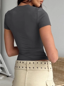 Rear view detail of dark gray slim-fit T-shirt paired with eyelet cargo pants