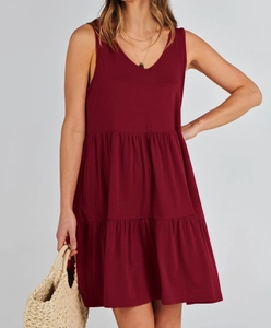 Detail of a maroon V-neck sleeveless tiered dress with soft knitted cotton blend fabric