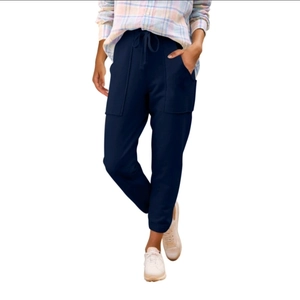 Dettaglio dei jogger blu scuro con coulisse in vita e ampie tasche cargo laterali