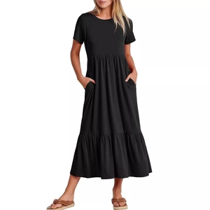 Detail view of the soft black tiered knit dress featuring short sleeves and side pockets