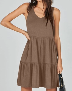 Detail of V-neck sleeveless tiered mini dress in dark brown with textured fabric