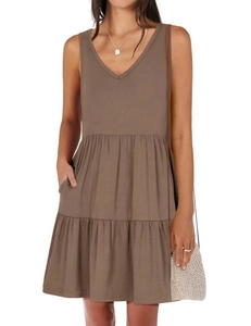 Detail view of the V-neck and tiered skirt design on this casual sleeveless taupe dress