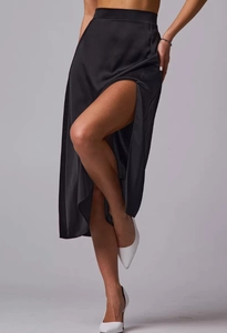 Detail of high waist black satin midi skirt with elegant side slit and silky texture