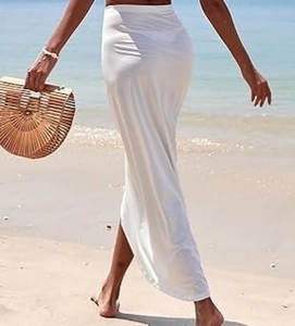 Detail view of white high-waisted wrap skirt with a silky texture and side slit for beachwear