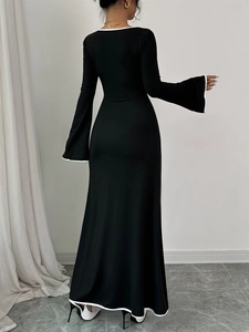 Elegant slim-fit black maxi dress with white contrast trim and flared sleeves back view