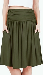Detailed close-up of smocked high waist and side pockets on olive green midi skirt