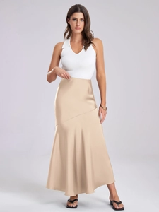 Close-up of elegant apricot satin midi skirt showing smooth texture and high-waist fit