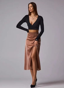 Detail of high waist satin midi skirt with elegant side slit and smooth silk texture