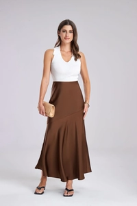 Detailed view of white ribbed sleeveless knit top paired with elegant brown satin skirt
