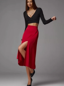 Detail of red satin midi skirt with side slit and black long sleeve crop top set