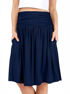 Detailed close-up of navy blue high-waisted pleated midi skirt with elastic waist and pockets