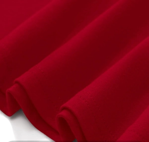 Detail of red sleeveless dress showing soft fabric texture and double-stitch hemline sewing