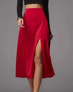 Detailed side view of high-waist red satin midi skirt featuring an elegant leg slit